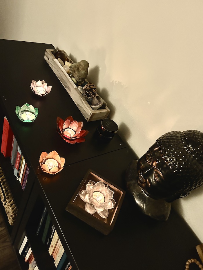 Elemental Therapy Studio side table showing Five elemental candles and other peaceful meaningful decorations