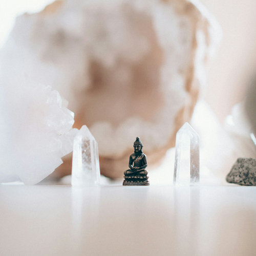 Graphic showing circle of The Five Element of Life Acupuncture: Metal: Clear crystals with statue of buddha - large crystal stone in background